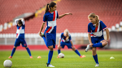 Soccer players stretching before a game.