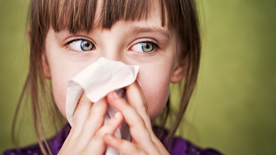 Girl blowing nose