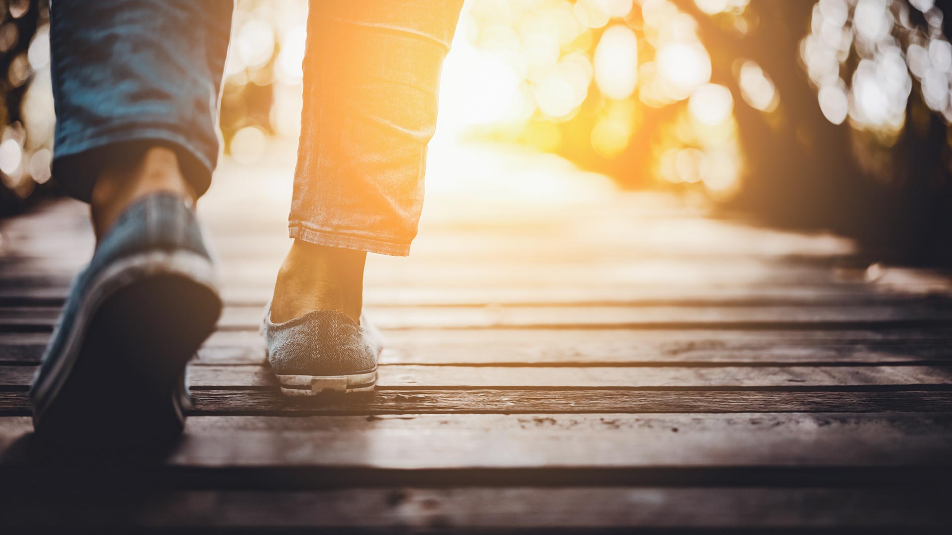 Close up woman walk in to the wild with sunset and sunlight background