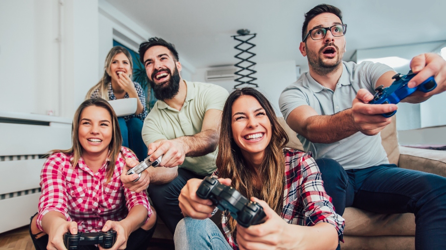 Group of friends having fun playing video games