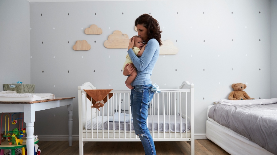 Mother holding baby in nursery