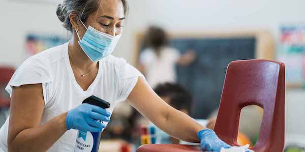 Woman cleaning classroom