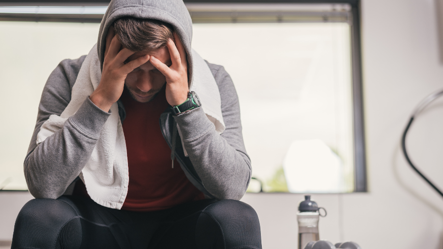 Man stressed out about health issues at gym.