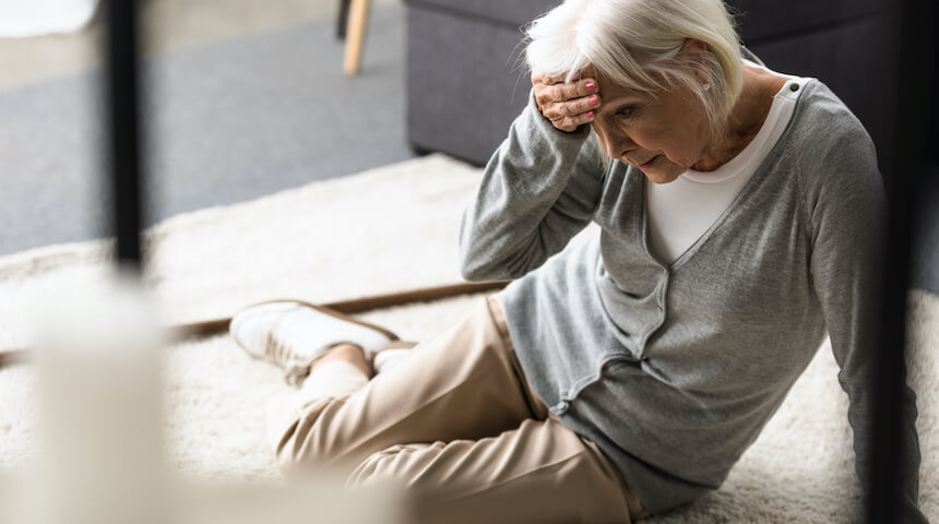 Woman holding head on floor