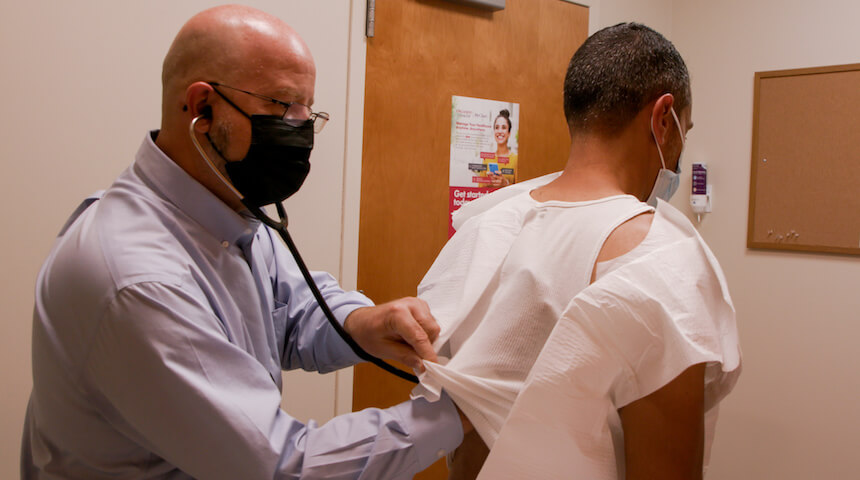 Doctor examining patient's back