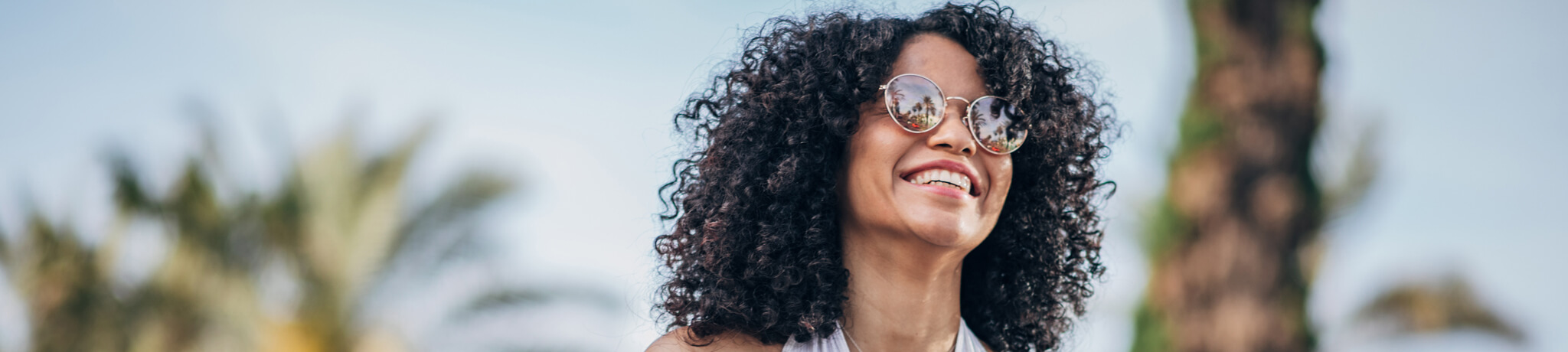 Woman with sunglasses smiling