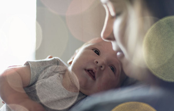 Mother holding child.