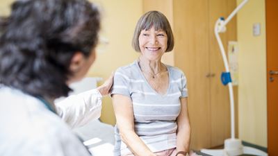 doctor talking with elderly woman