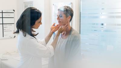 Doctor tests womans lymph nodes