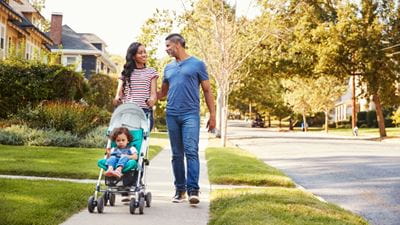 Family walking on sidewalk