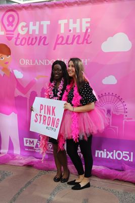 Girls smile with Pink Strong sign at Hope Hike