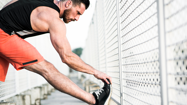 Athlete stretching muscles after a run.