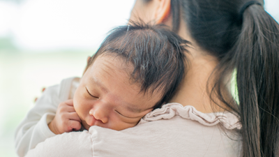 Mother holding newborn baby.