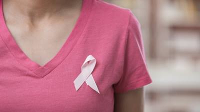 Woman in pink shirt with pink ribbon