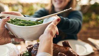 Woman passes green beans