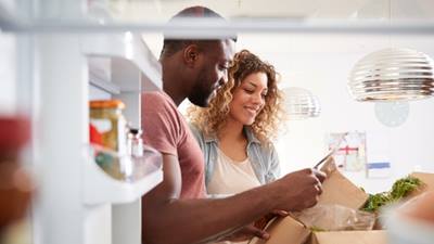 a couple unpacking groceries together