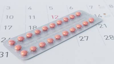 Birth control pills on calendar