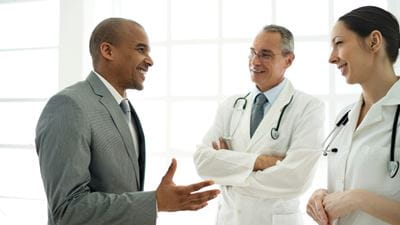 Businessman speaking to doctors