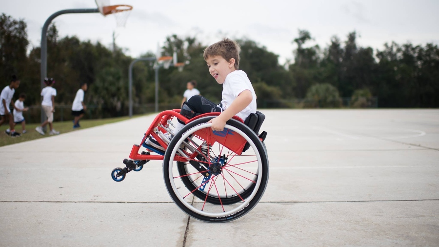 Child in wheelchair on basketball court