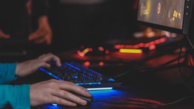 close-up of hands playing computer game