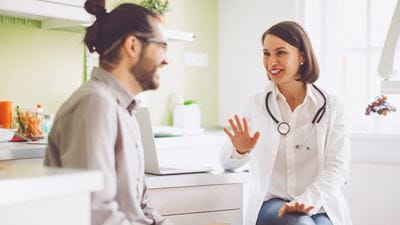 doctor having consultation with her male patient