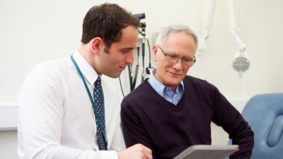 Male doctor going over results with male patient