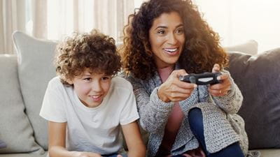 Mom playing a video game with her son