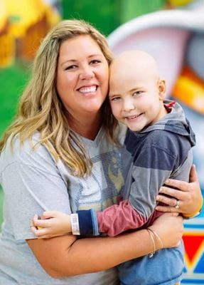 Mother and son hugging and smiling