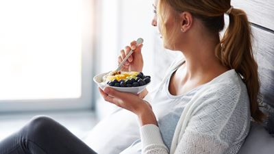 Pregnant woman eating fruit