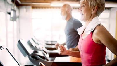 senior woman and man on treadmill