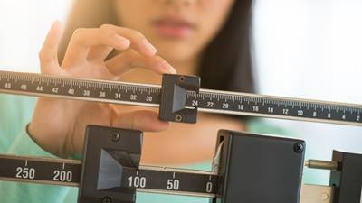 Woman adjusting a scale