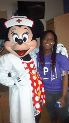 Woman smiles with Minnie Mouse