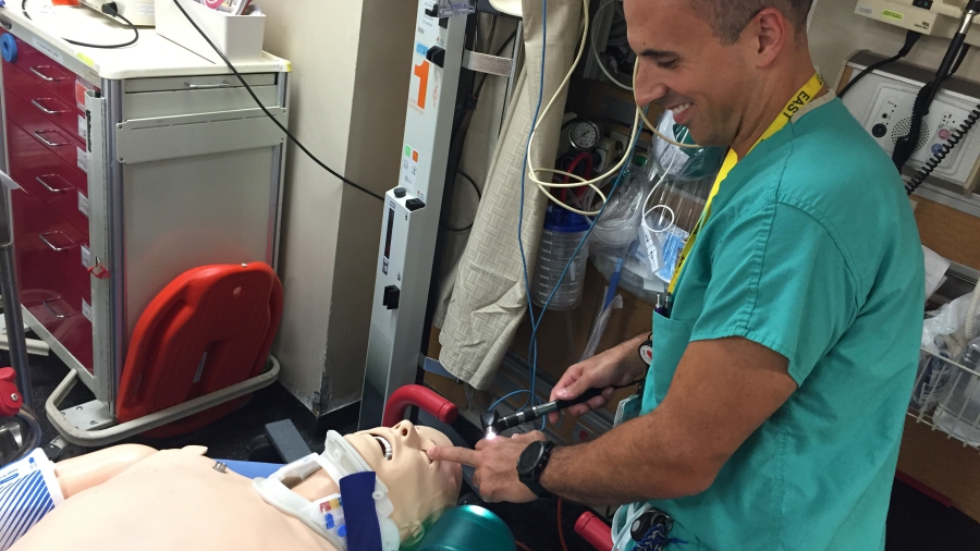 Joseph Ibrahim, MD, working with a dummy patient.