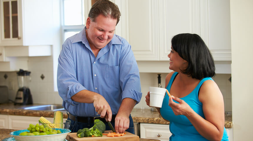 Man and woman prepping food in kitchen