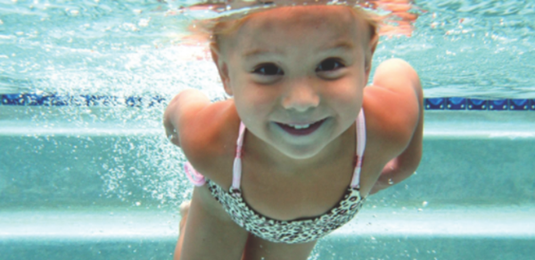 Child swimming underwater. 