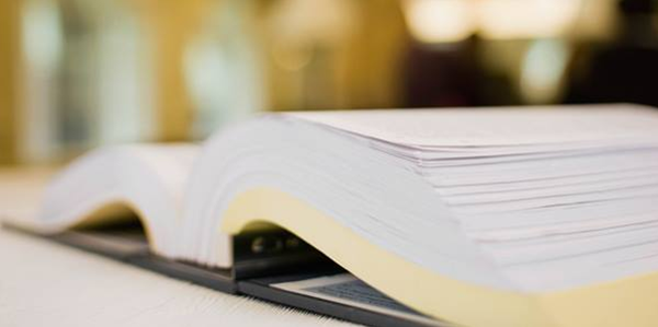 Open book laying on a table.