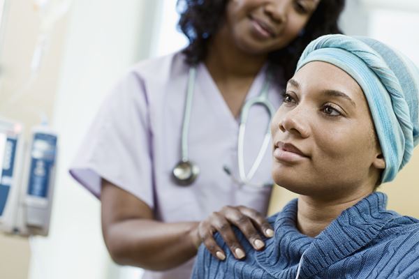 Female cancer patient being treated by a nurse.