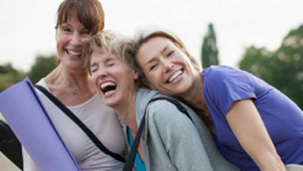 Three women laughing together.