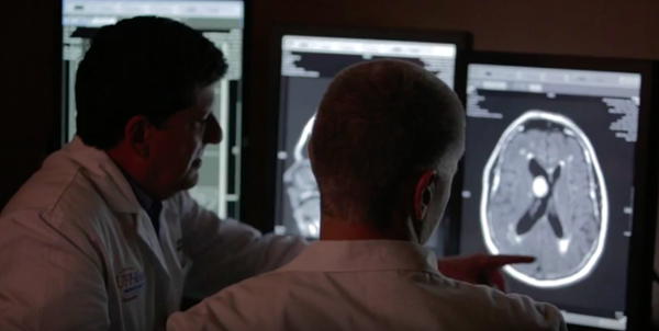 Two doctors reviewing brain scan.