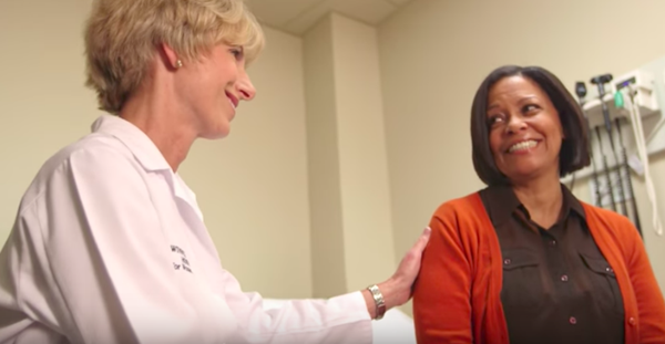 Women's health physician speaking to a patient.