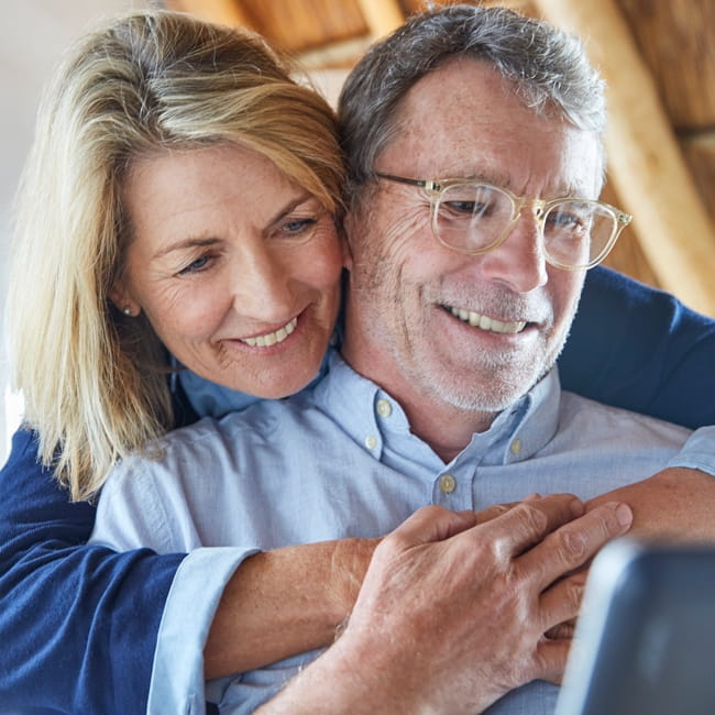 Couple on computer hugging