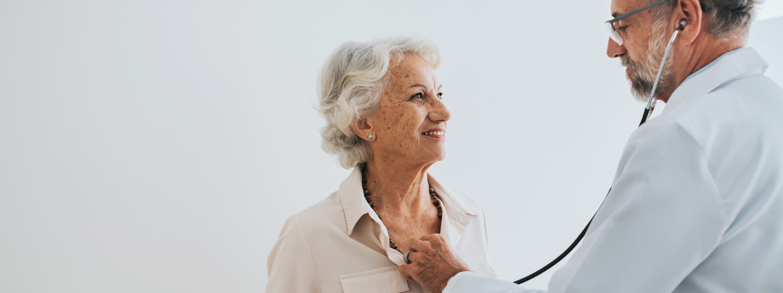 doctor using stethoscope on patient