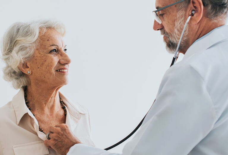 doctor using stethoscope on patient