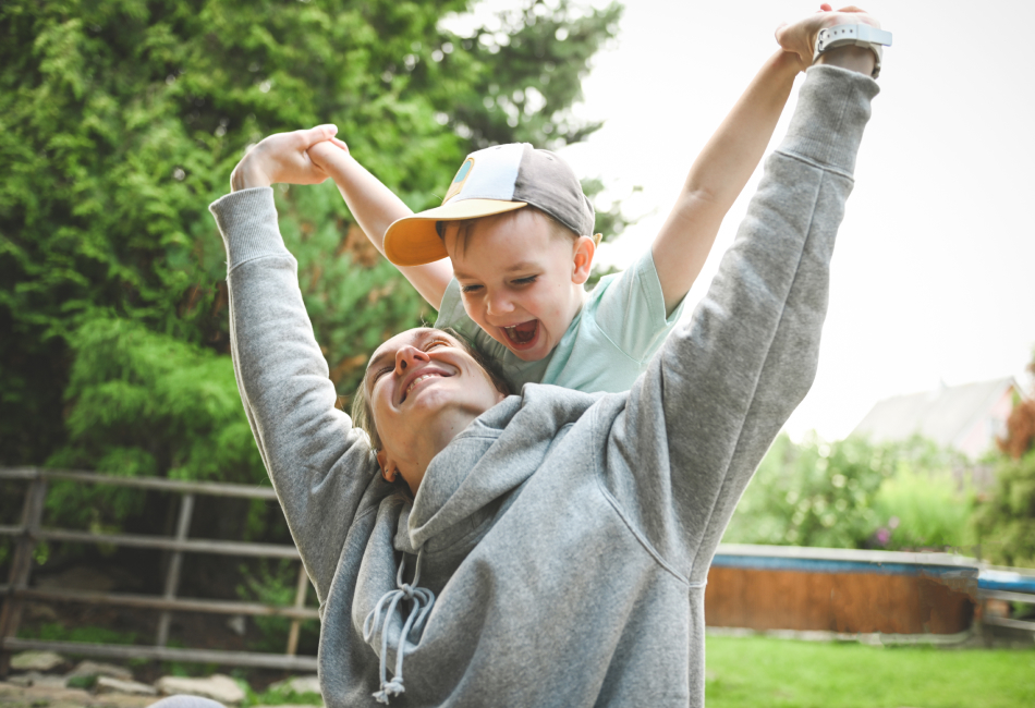 Mother giving son a piggy back ride