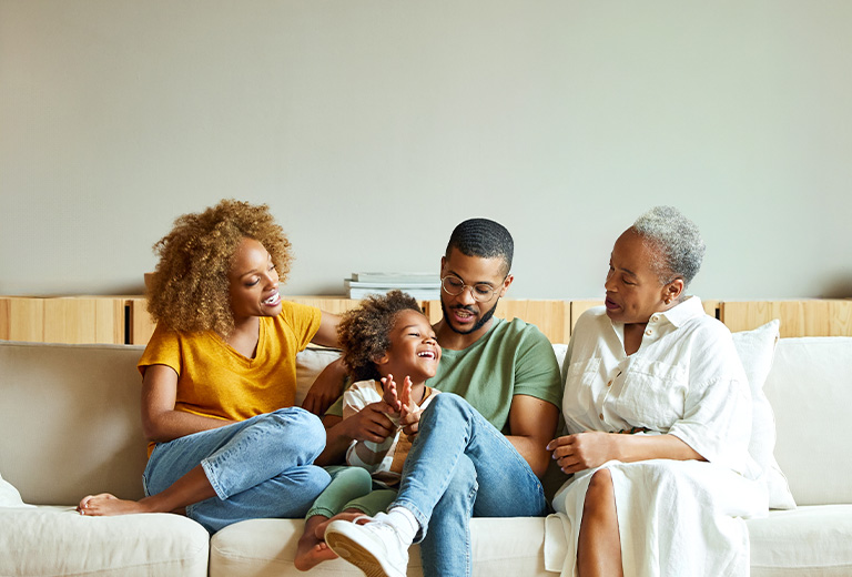 Family smiling on couch