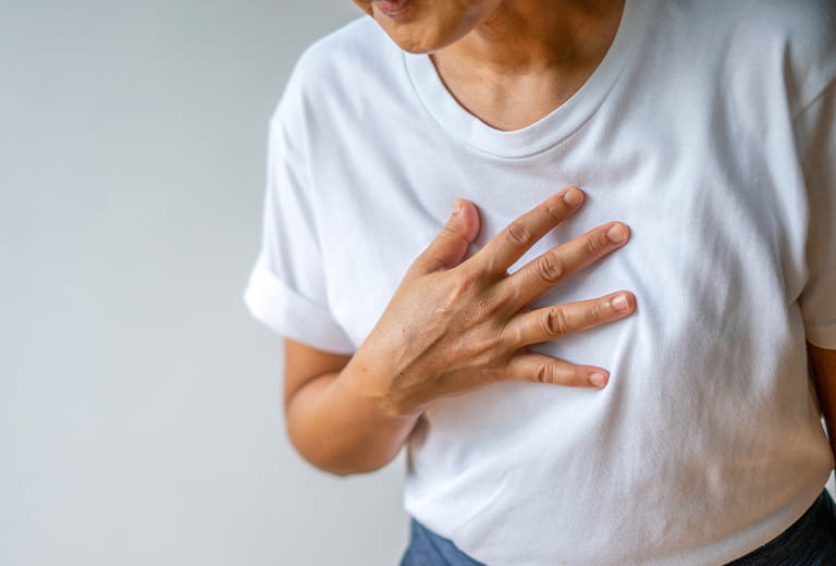person with hand on their chest