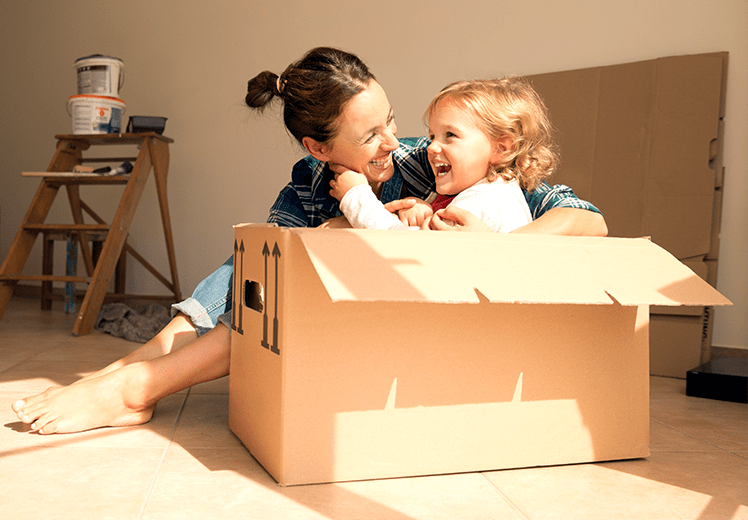 Mother and daughter playing in a box