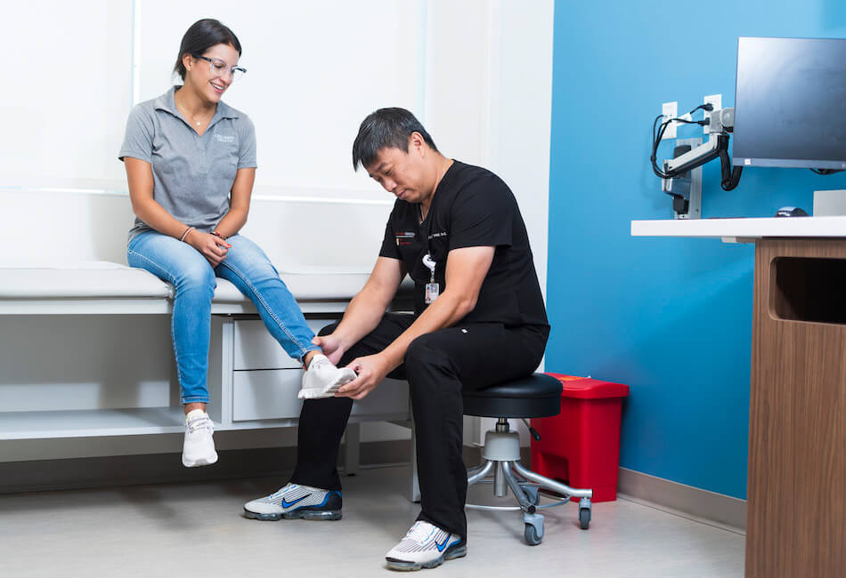 doctor checking patient's foot