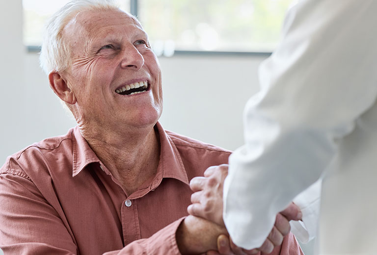 Old man shaking doctors hand