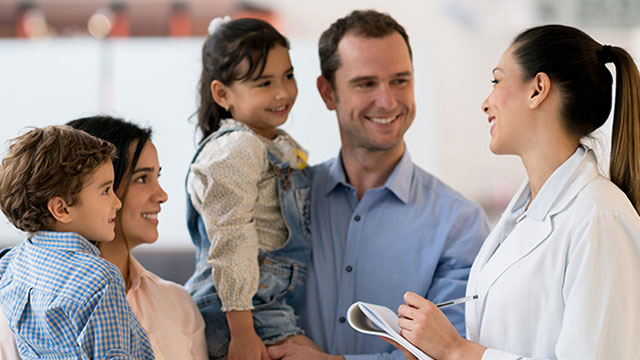 Physician talking to smiling family